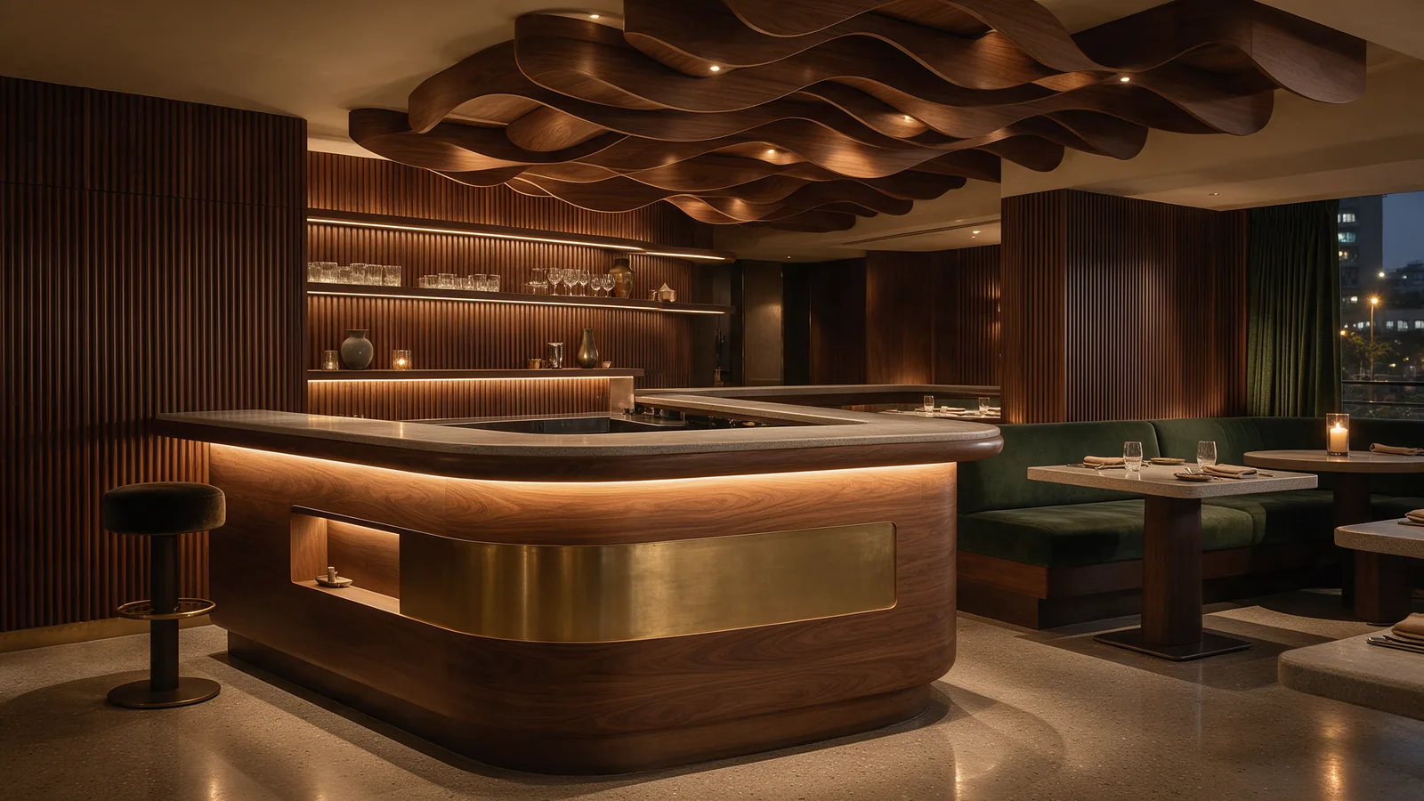Premium restaurant interior with a walnut and stone bar counter, fluted panelling and green velvet banquettes